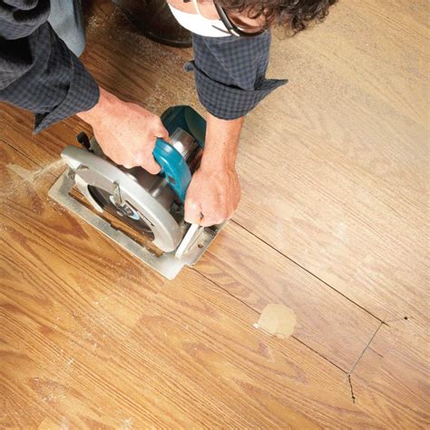 finishing touches on repaired laminate flooring